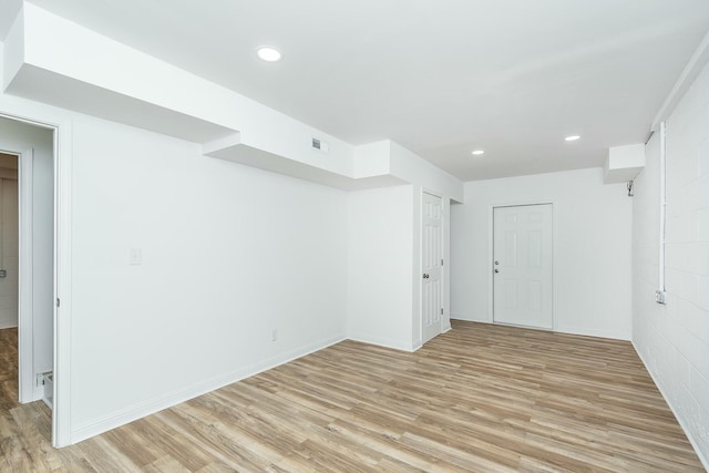 unfurnished room with recessed lighting, baseboards, visible vents, and light wood finished floors