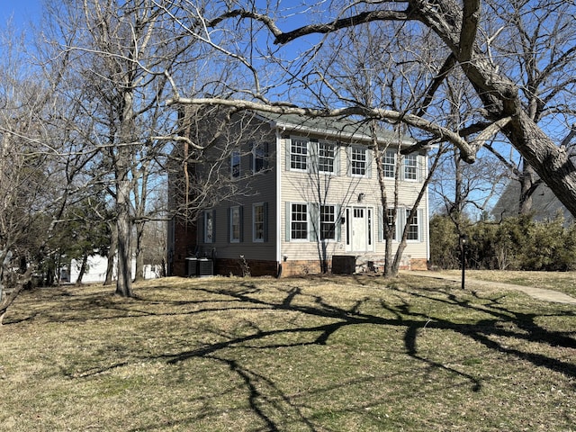 exterior space featuring central AC and a front lawn