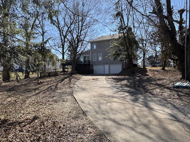 view of side of property with a garage and driveway