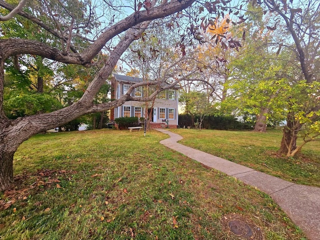 colonial home with a front lawn