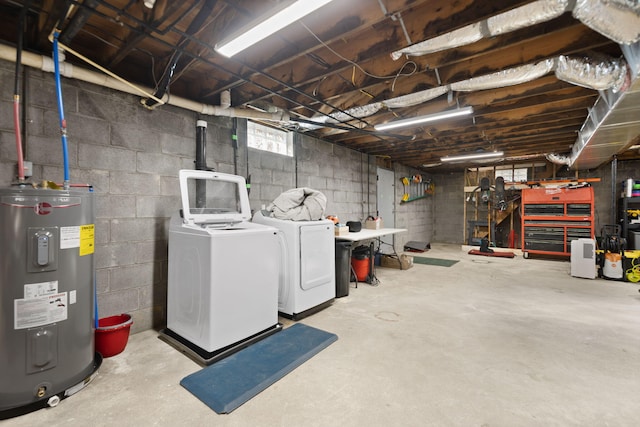 basement with electric water heater and washer and clothes dryer