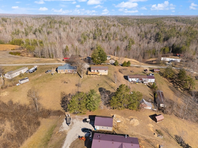 birds eye view of property with a wooded view