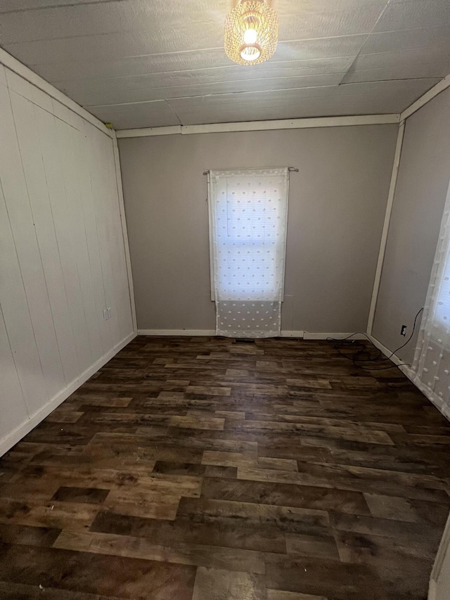 empty room with baseboards and wood finished floors