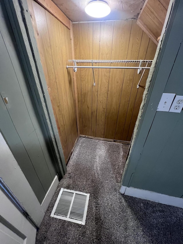 spacious closet featuring lofted ceiling and visible vents