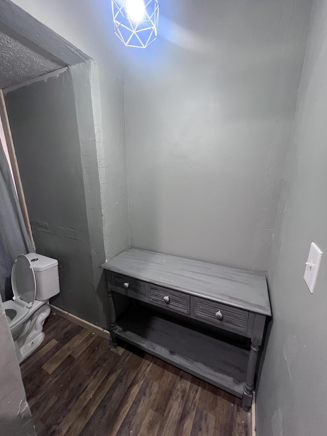 bathroom featuring toilet and wood finished floors