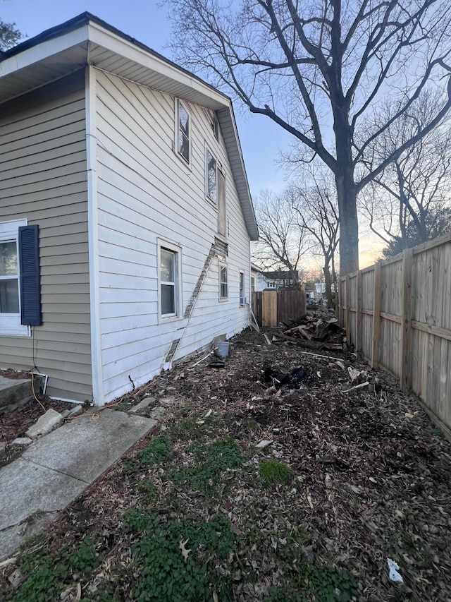 view of side of property featuring fence