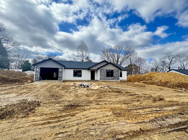 view of front of house with a garage and stone siding