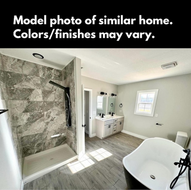 bathroom featuring vanity, a soaking tub, walk in shower, and visible vents