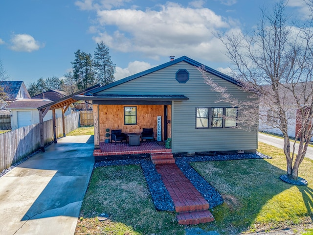 view of front of home with a front yard, covered porch, and fence