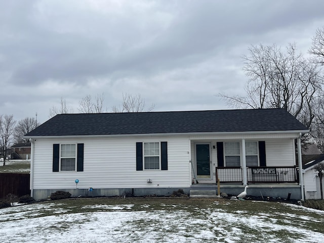 view of front of house with a shingled roof and covered porch