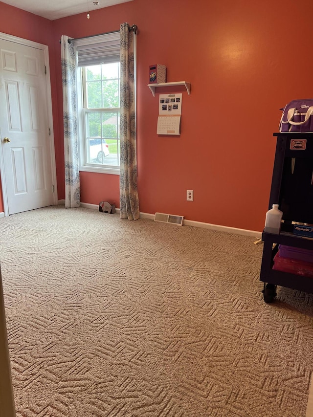 bedroom featuring carpet floors, visible vents, and baseboards