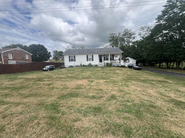 view of front of property with a front lawn and fence