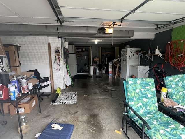 garage featuring a garage door opener and freestanding refrigerator