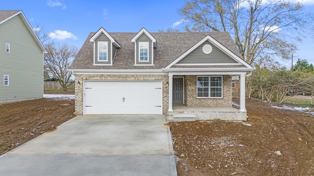 view of front of home featuring concrete driveway, a porch, an attached garage, and brick siding