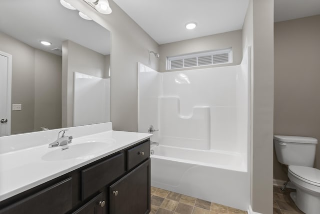 full bath with shower / tub combination, vanity, and toilet