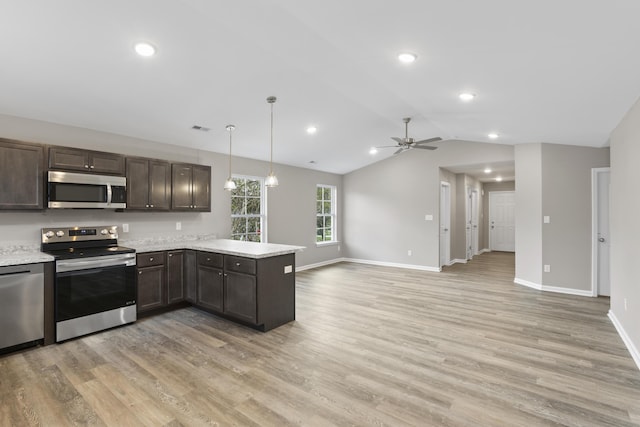 kitchen featuring light wood-style flooring, a peninsula, vaulted ceiling, dark brown cabinets, and appliances with stainless steel finishes