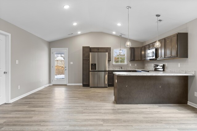 kitchen featuring appliances with stainless steel finishes, visible vents, a peninsula, and dark brown cabinets