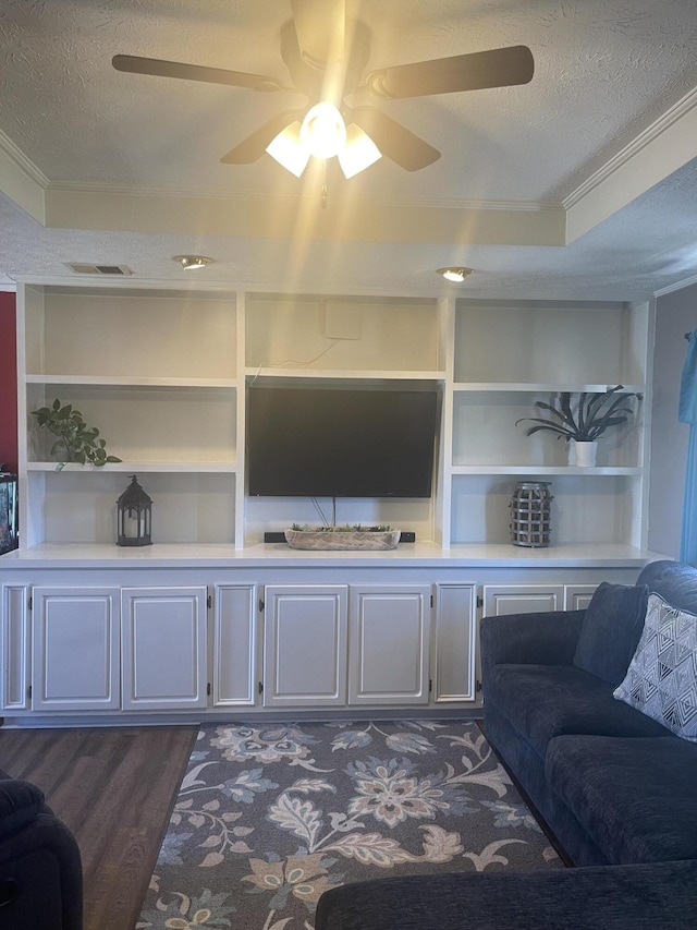 living room featuring dark wood-style floors, a textured ceiling, and built in features