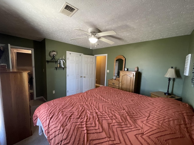 bedroom with arched walkways, a textured ceiling, visible vents, a ceiling fan, and a closet