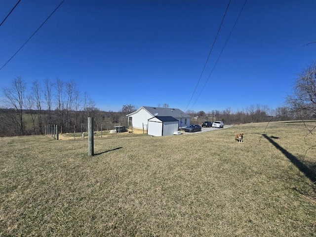 view of yard with an outdoor structure and a shed