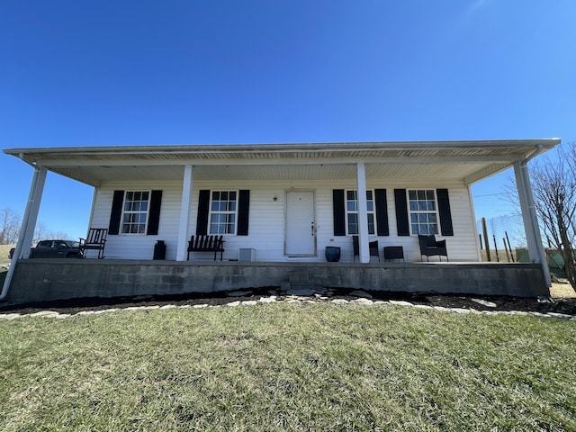 view of front of home featuring covered porch and a front lawn