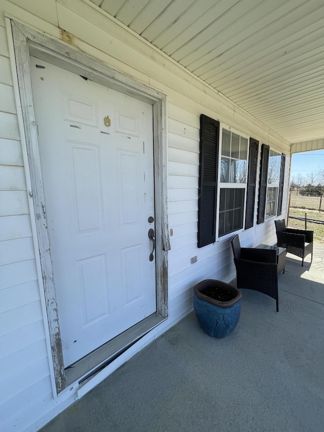 view of exterior entry with covered porch