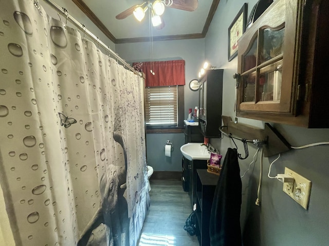 full bath with toilet, wood finished floors, vanity, a ceiling fan, and ornamental molding