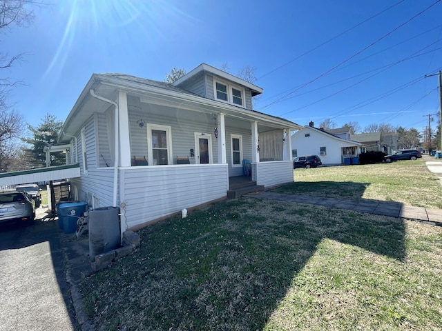 bungalow-style house featuring a front lawn and a porch