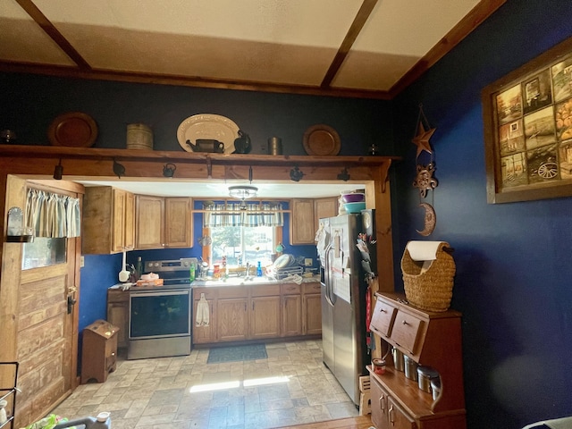 kitchen with stone finish floor, brown cabinets, stainless steel appliances, light countertops, and a sink