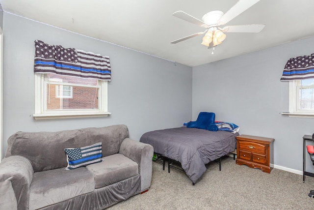 carpeted bedroom with a ceiling fan and baseboards