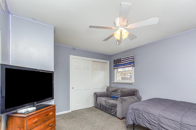 bedroom featuring a closet, carpet floors, baseboards, and ceiling fan