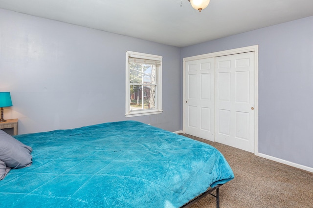 bedroom featuring carpet, baseboards, and a closet