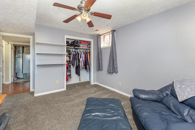 bedroom with a closet, carpet flooring, a textured ceiling, and baseboards