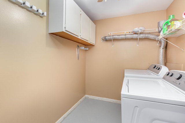 laundry area featuring washer and dryer, baseboards, and cabinet space