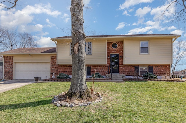 raised ranch featuring a front yard, brick siding, a garage, and driveway