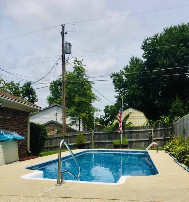 view of swimming pool featuring a patio, a fenced backyard, and a fenced in pool