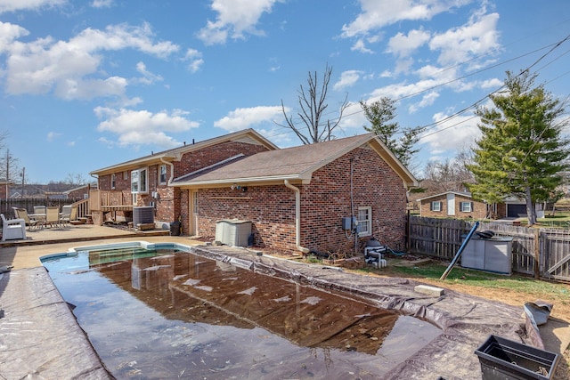 view of swimming pool with a deck, a patio, cooling unit, and a fenced backyard