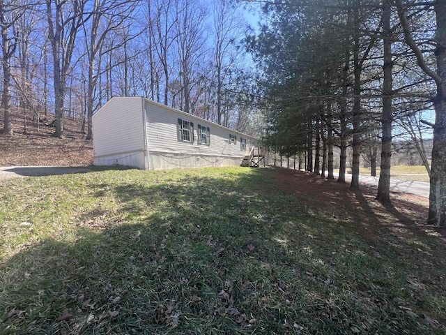 view of property exterior with a yard