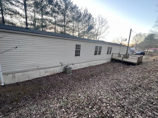 back of property featuring a deck, central AC, and crawl space