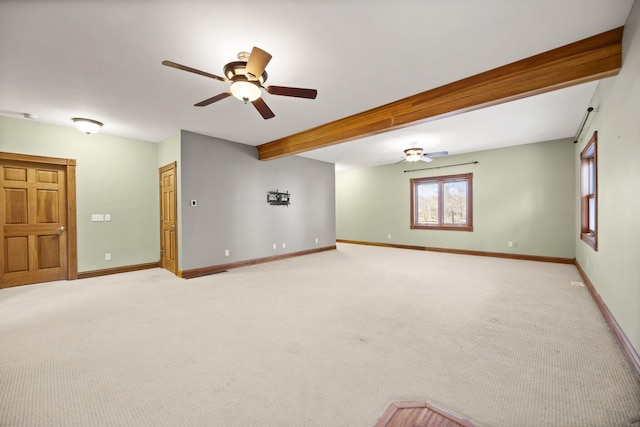 unfurnished room with beamed ceiling, baseboards, light colored carpet, and a ceiling fan