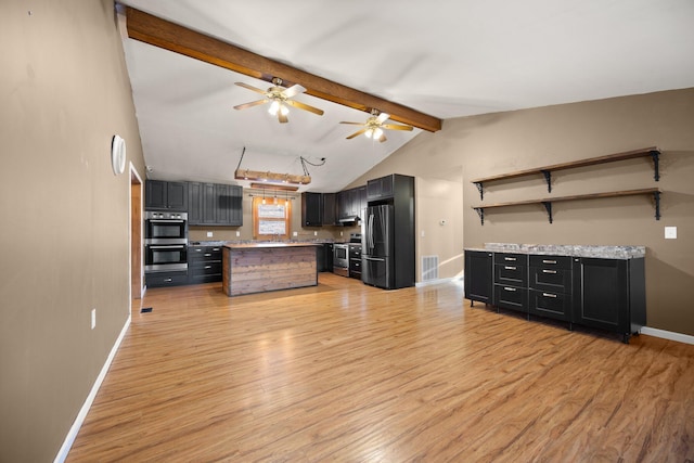 kitchen featuring light wood finished floors, appliances with stainless steel finishes, light countertops, and open shelves