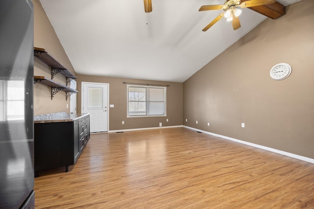 unfurnished living room featuring high vaulted ceiling, a ceiling fan, light wood-type flooring, and baseboards