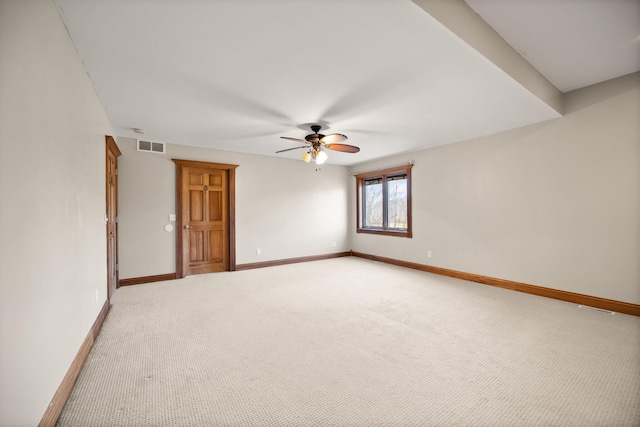 unfurnished room with visible vents, a ceiling fan, light colored carpet, and baseboards