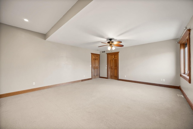 empty room featuring a ceiling fan, visible vents, baseboards, recessed lighting, and light colored carpet