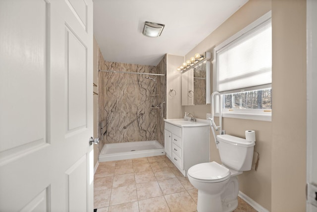 full bathroom featuring vanity, baseboards, a marble finish shower, tile patterned floors, and toilet