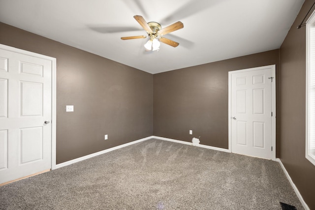 unfurnished room featuring baseboards, ceiling fan, and carpet flooring