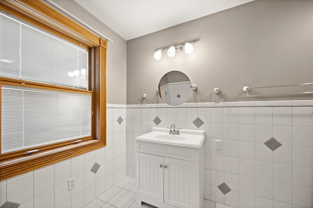 bathroom with vanity, tile walls, and wainscoting