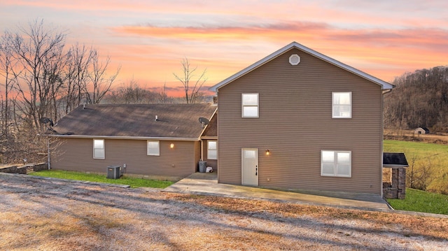 back of house featuring central AC