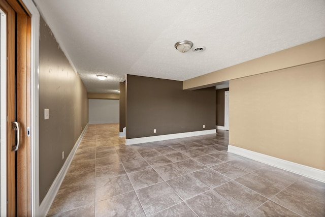 1343 Bastin Creek Rd, Kings Mountain, KY 40442 - spare room featuring baseboards, tile patterned flooring, a textured ceiling, and visible vents