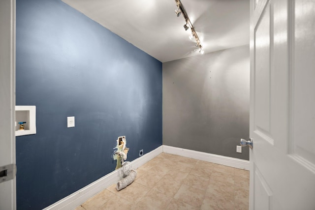 laundry room featuring baseboards, washer hookup, laundry area, rail lighting, and tile patterned floors